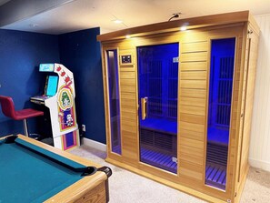 A room with a pool table, a sauna, and a gaming machine. - GolfSim HotTub PS5 Sauna Thtr Pooltbl 6BR 5BA 420 (Thornton, CO, 80602)