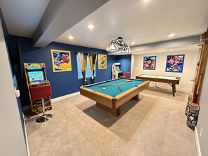 A room with a pool table, arcade games, and anime-themed wall art. - GolfSim HotTub PS5 Sauna Thtr Pooltbl 6BR 5BA 420 (Thornton, CO, 80602)