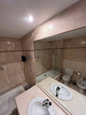 A modern bathroom with a large mirror, two sinks, a shower, and a toilet. - Marbella Magna Apartment With Stunning Views (Marbella)