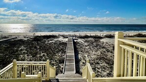 A wooden boardwalk leading to a beach with a clear sky and sun shining. - Moonlight Sonata - Gulf Front (St. George Island)