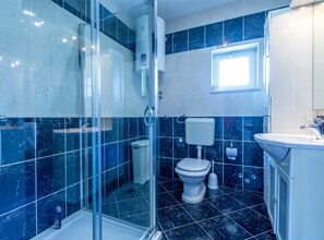 A modern bathroom with a glass shower enclosure, a toilet, and a sink. - Serene Rural Villa With Pool, Sun Deck, and Children's Play Area (Omis)