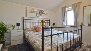 A bedroom with a bed, a bedside table, a mirror, and a window with curtains. - Calm Countryside Rovinj Manor With Pool (Rovinj)
