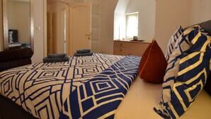 A bedroom with a large bed, a dresser, a mirror, and a window. - Blissful Bay Apartment Rovinj Center (Rovinj)