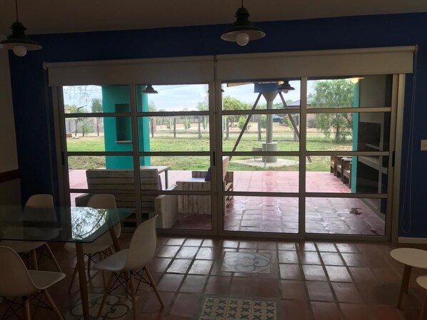 A room with a glass door leading to an outdoor patio area.