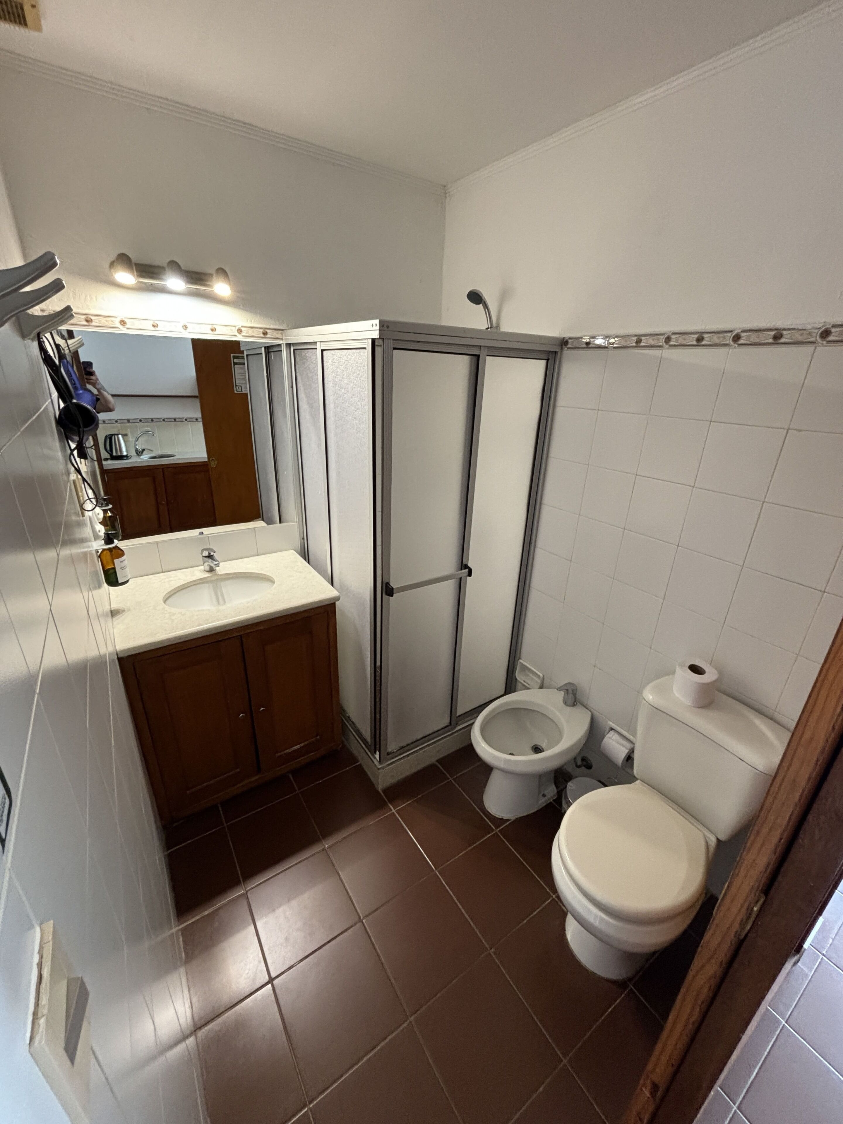 A bathroom with a sink, toilet, and shower.