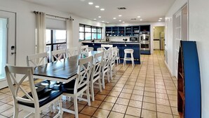 A spacious kitchen with a dining area, featuring a large island, modern appliances, and ample natural light. - Pirate's Paradise | Waterfront & Private Pool (Rockport)