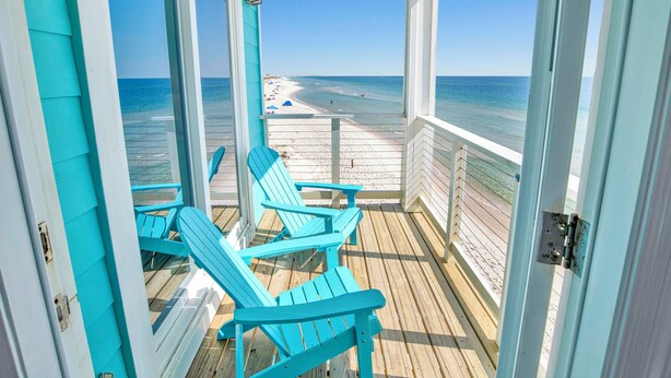 A covered deck with turquoise Adirondack chairs overlooking a beach. - Beachfront Escape | Pet Friendly | Fort Morgan (Gulf Shores)