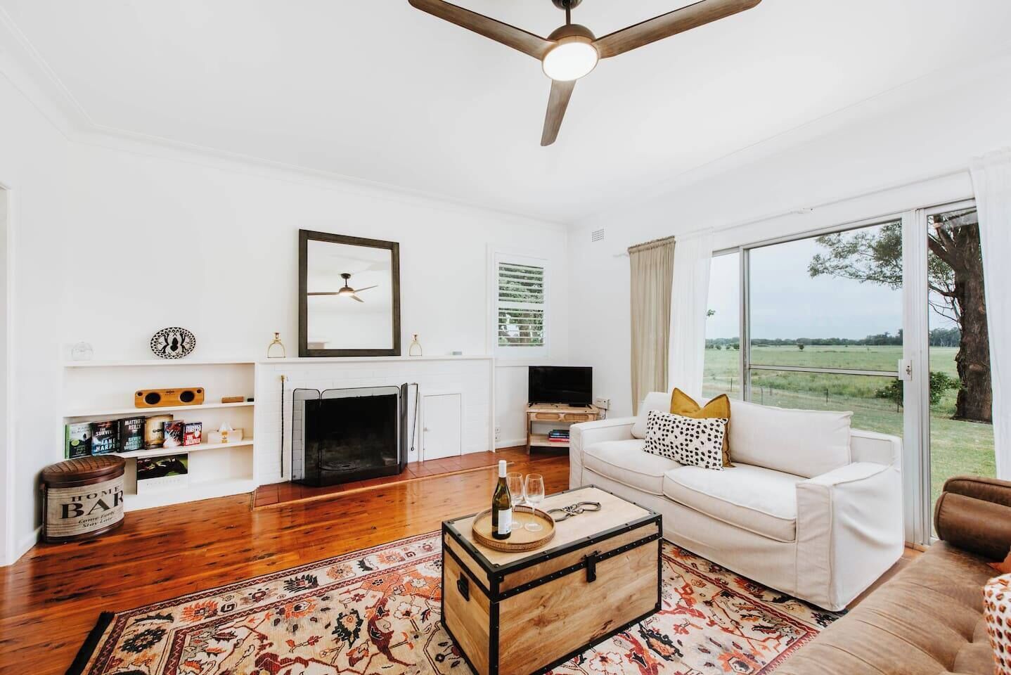 The main living area centres around a wood-burning fireplace—perfect for cosy winter evenings.