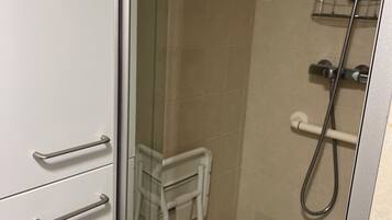 Shower, hair dryer, towels, toilet paper