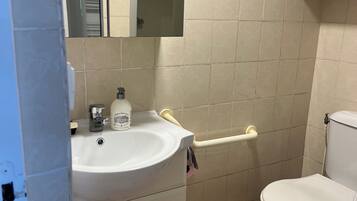 Shower, hair dryer, towels, toilet paper