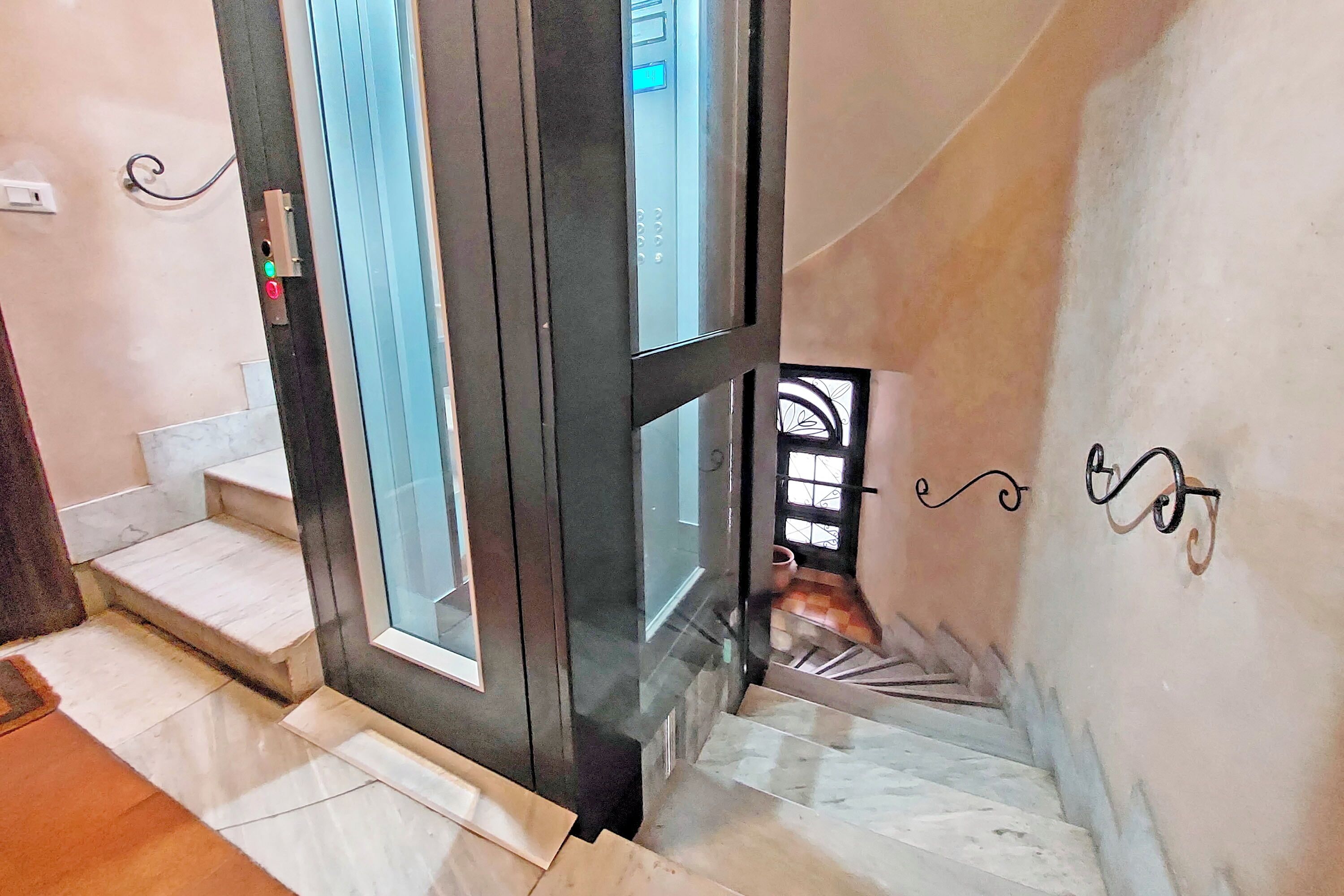 A staircase with a glass door leading to a landing.