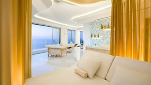 A modern hotel room with a large bed, a vanity with a mirror, and a view of the sea. - Luxury room in a 5 star Hotel in Puerto Vallarta Beaches Mex. (puerto vallarta)
