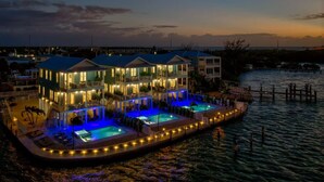 A waterfront hotel with multiple balconies and a pool area. - World-Class 5 Bed Villa  Oceanfront Pool/Hot tub Sunset Escape Sleeps 12 (Marathon)