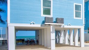 A two-story building with a blue exterior and white trim. - World-Class 5 Bed Villa  Oceanfront Pool/Hot tub Sunset Escape Sleeps 12 (Marathon)