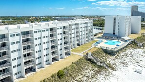 A multi-story hotel with a pool area and beach access. - Beach House 201D - Gulf Front Resort! (Miramar Beach)