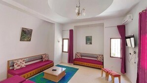 A room with two sofas, a coffee table, and a bench. - Sweet Villa Residence (Houmt Souk)