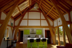 A spacious interior with a high wooden ceiling and large windows. - Peaceful Nature Retreat in Othery (Bridgwater)