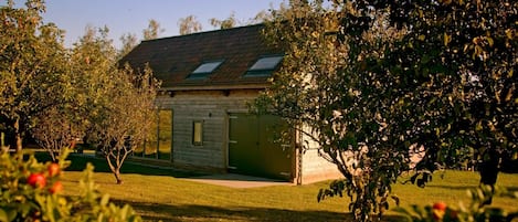 A wooden building with a sloped roof and a window.