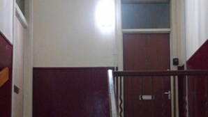 A staircase with a handrail leading to a landing. - Snug - Grian-aig Apartment (Greenock)