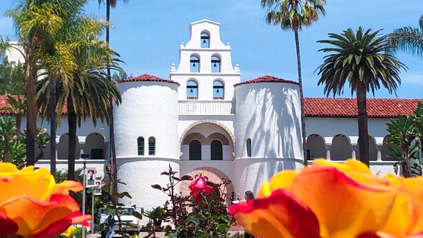 A white building with a bell tower, surrounded by palm trees. - Modern Peaceful Tucked Away With Private Office (San Diego)