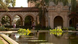 A courtyard with a fountain, palm trees, and an ornate building with arches. - On Omni La Costa Golf Course- Patio, Parking, & AC (Carlsbad)