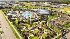 An aerial view of a resort with a swimming pool, landscaped areas, and a parking lot. - 5 BD/ 4.5 BA/ Windsor Cay (1240 BI) (Clermont)