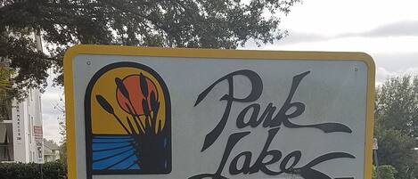 A sign for 'Park Lakes' with a colorful logo and a cursive 'Lakes' text.
