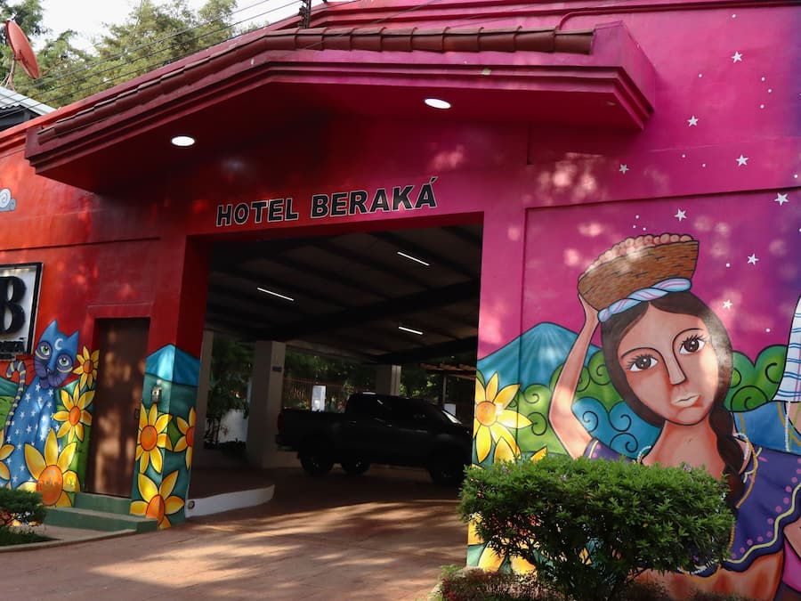 A building with a colorful mural and the sign 'HOTEL BERAKA' above the entrance.
