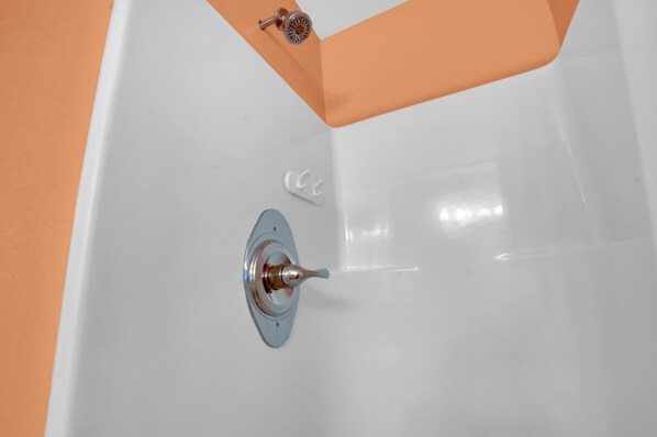 Relax in a spacious bathtub with a convenient faucet.