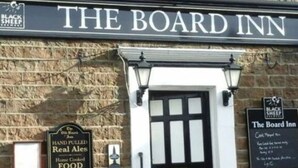 A brick building with a sign reading "THE BOARD INN". - OYO The Board Inn (Hawes)