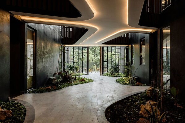Walk through lush surroundings and enjoy the unique ceiling design with integrated lighting.
