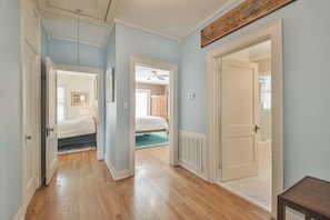 Enter a serene bedroom with a comfortable bed and natural light pouring in through the window.