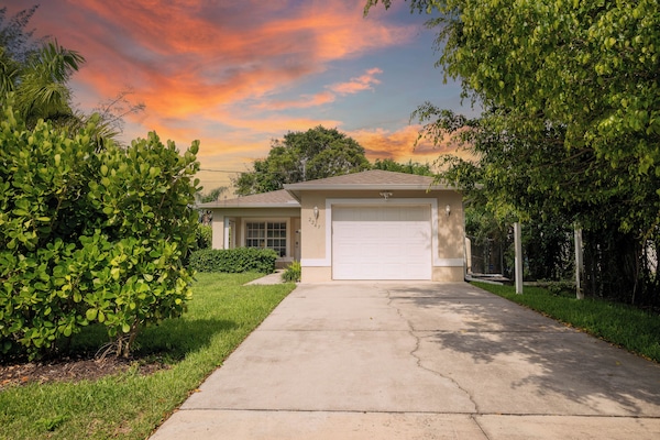 Front of the house. One car garage and long driveway.