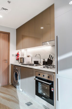 Private kitchen - Charming 1-bedroom apartment in lovely Azizi Riviera with AC, WiFi (Azizi Riviera, Meydan One, Meydan City)