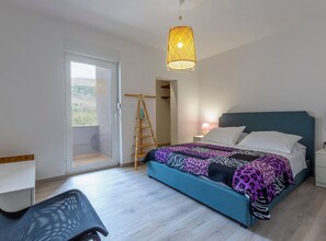 A bedroom with a bed, a desk, a chair, a ladder, and a hanging light fixture. - Serene Rural Villa with Pool, Sun Deck, and Children's Play Area - Five Bedroom Villa (Tugare)