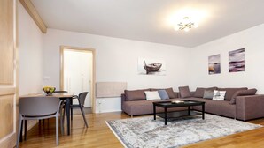 A modern living room with a sofa set, a coffee table, and a dining area with chairs. - Charming Bright Gem Rovinj Downtown - Two Bedroom Apartment with Terrace (Rovinj)