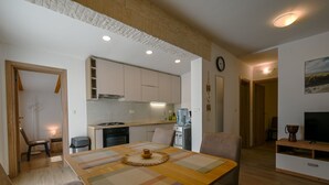 A modern kitchen with white cabinets, a built-in stove, and a water dispenser. - Rovinj Countryside Escape Holiday Home - Two Bedroom Holiday Home with Terrace (Rovinj)