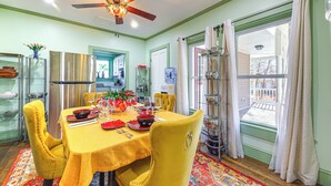 A dining area with a yellow tablecloth, yellow chairs, and a ceiling fan. - 18 Mi to Skiing: Colorful Home in Springfield! (Springfield)