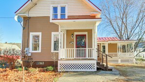 A two-story house with a porch, a satellite dish, and a red door. - 18 Mi to Skiing: Colorful Home in Springfield! (Springfield)