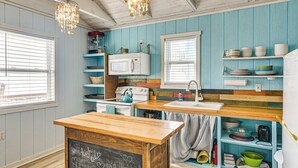 A kitchen with wooden countertops, a white stove, and a chalkboard sign. - Beachfront Cottage w/ Boardwalk in Freeport (Freeport)