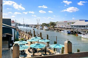Relax by the marina with outdoor seating and dining areas under shaded umbrellas.