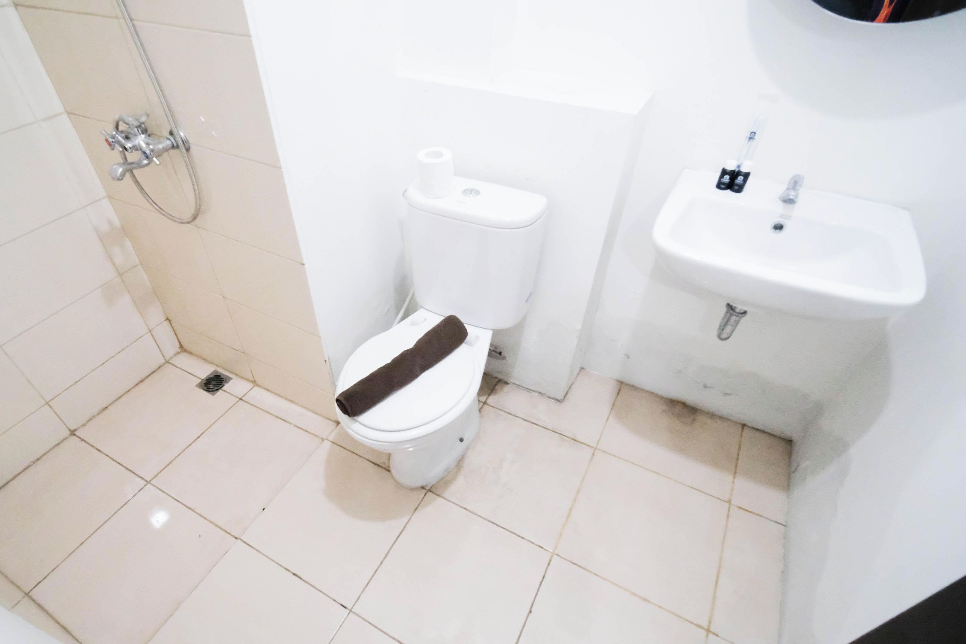 A small, clean bathroom with a toilet, bidet, and sink.