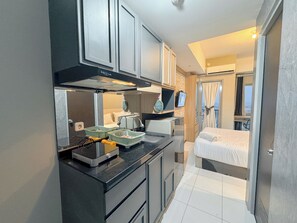Deluxe Studio | Private kitchen | Fridge, stovetop, rice cooker - Cozy Stay And Best Value Studio At Tamansari Prospero Apartment (Sidoarjo)