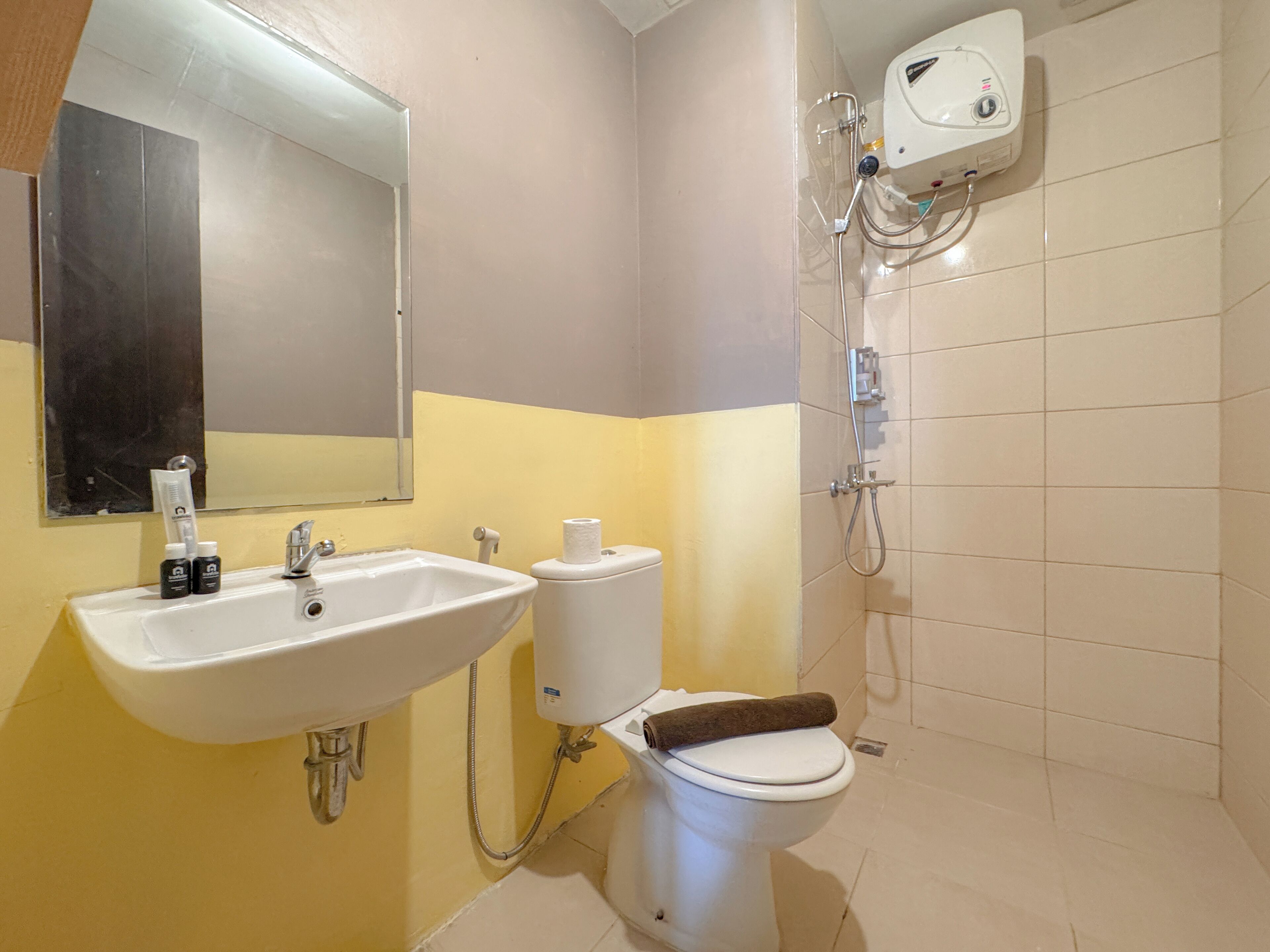 A bathroom with a sink, toilet, and shower.