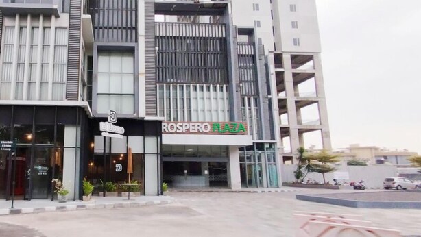 A multi-story building with a commercial ground floor featuring a storefront with a sign reading "ROSPERO PLAZA". - Simply And Good Place 2Br At Tamansari Prospero Apartment (Sidoarjo)