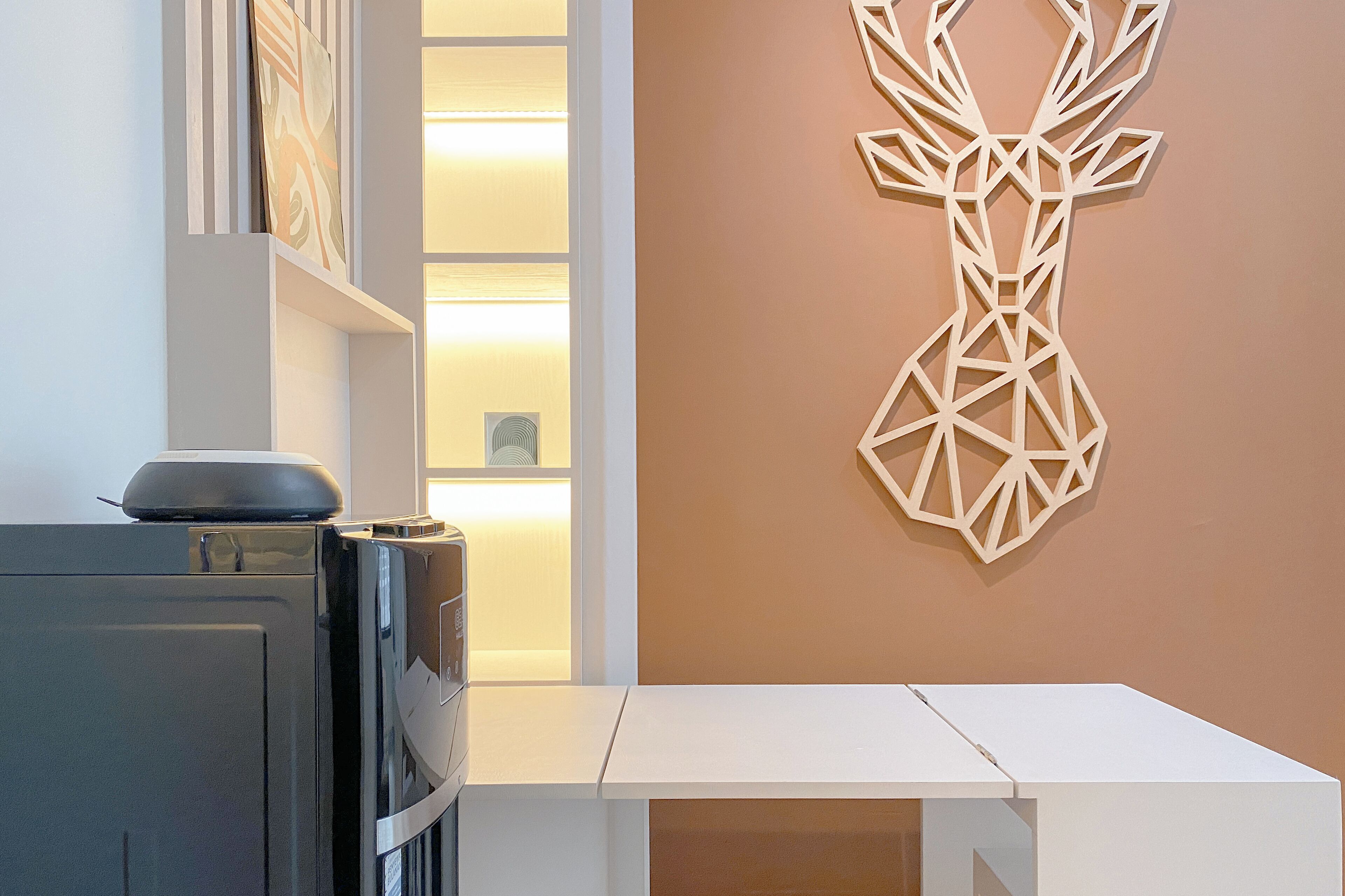 A modern kitchen with a built-in oven and a white countertop.