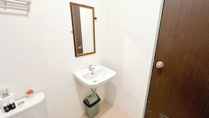 A small bathroom with a white sink, a mirror, and a toilet. - Nice And Comfortable Stay 2Br At Tamansari Prospero Sidoarjo Apartment (Sidoarjo)
