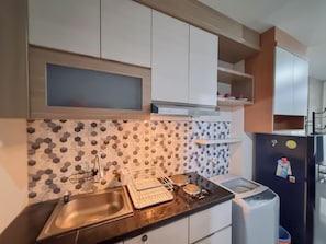 Apartment | Private kitchen | Fridge, stovetop, rice cooker - Elegant And Spacious 2Br Loft Green Park Yogyakarta Apartment (Depok)