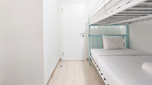 A bunk bed room with a white door and a skylight above. - Comfort And Homey 2Br At Podomoro City Deli Medan Apartment (Medan)