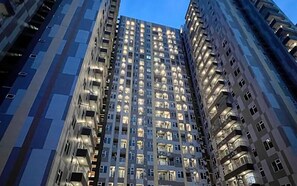 A high-rise building with multiple floors, each with numerous windows and balconies. - Comfort And Homey 2Br At Podomoro City Deli Medan Apartment (Medan)
